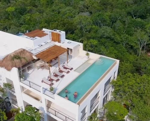 an aerial view of a building with a swimming pool at Tulum jungle penthouse in Chemuyil