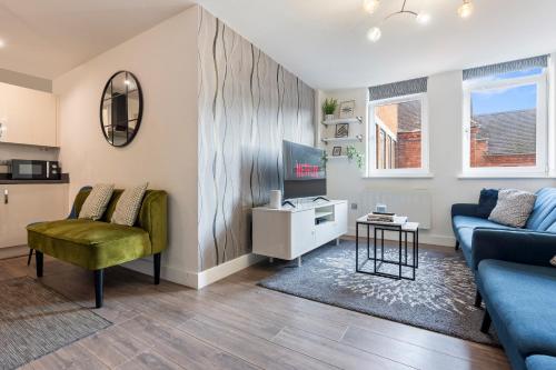 a living room with a couch and a table at OPK STAYS - Stylish City Centre 1 bed Apartment, Near train station, FREE parking Netflix, SLEEPS 4 in Coventry