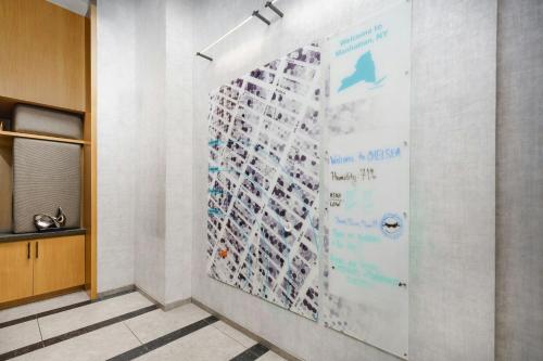 a wall with a large poster on it in a hallway at TownePlace Suites by Marriott New York Manhattan/Chelsea in New York