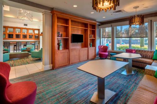 a living room with a couch and a tv at Residence Inn by Marriott Ocala in Ocala