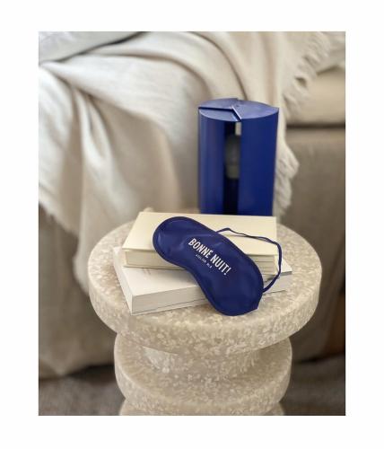 a blue computer mouse sitting on a table with books at Atelier Blå houses in Rösselvik