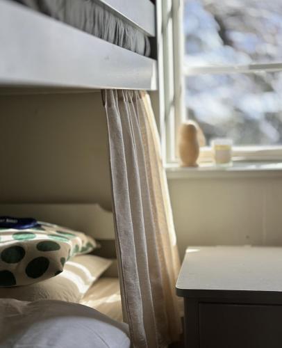 a bedroom with a bunk bed with a window at Atelier Blå houses in Rösselvik