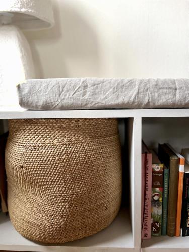 a shelf with a pillow on top of a book shelf at Atelier Blå houses in Rösselvik