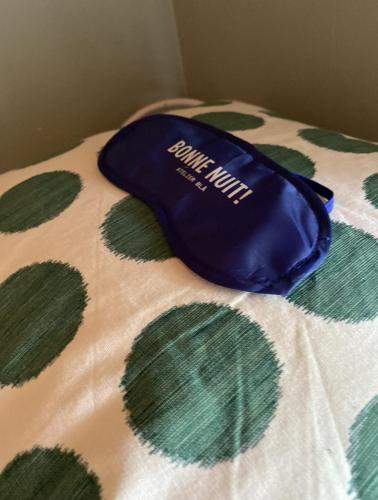 a blue hat sitting on top of a bed at Atelier Blå houses in Rösselvik