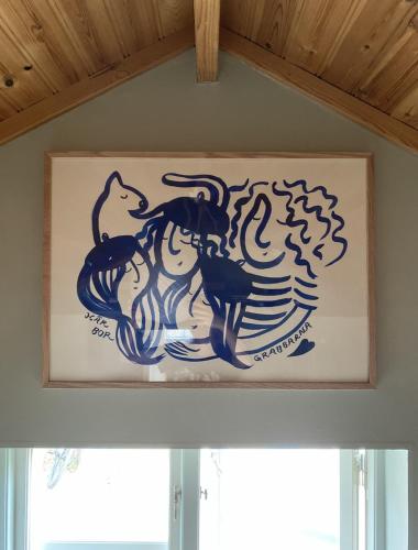 a picture of a painting of animals on a wall at Atelier Blå houses in Rösselvik