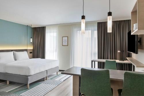a bedroom with a bed and a desk and a table at Residence Inn by Marriott Hamburg Altona in Hamburg