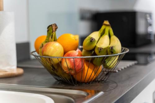 a bowl of fruit sitting on a counter at OPK STAYS - Stylish City Centre 1 bed Apartment, Near train station, FREE parking Netflix, SLEEPS 4 in Coventry