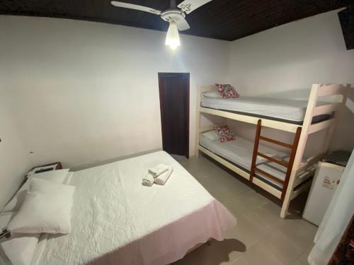 a bedroom with a bed and a bunk bed and a ladder at Pousada E Restaurante Passart in Morro de São Paulo