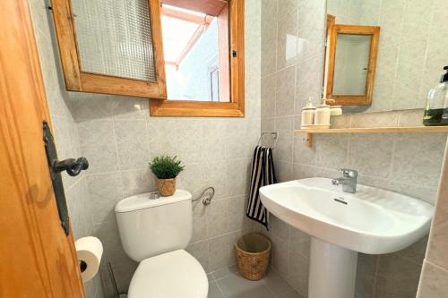 a bathroom with a toilet and a sink at Incredible Views from La Parata in Mojácar