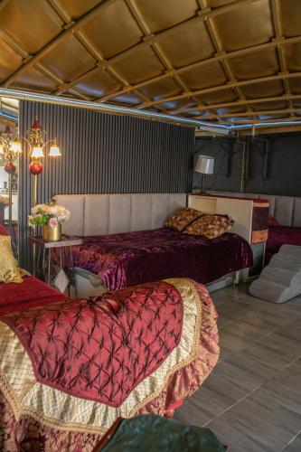 a bedroom with two beds with red comforters at EL DOMO jardín en Coyoacán in Mexico City