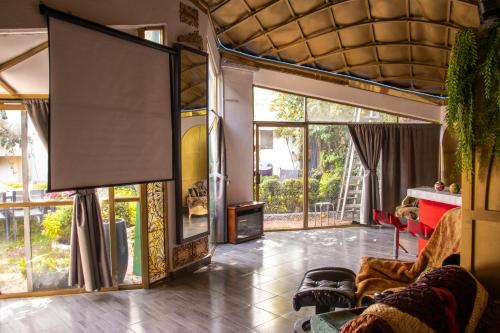 a living room with a large screen in a house at EL DOMO jardín en Coyoacán in Mexico City