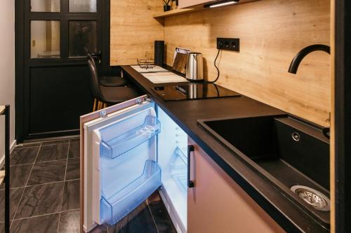 a small refrigerator in a kitchen with a counter at Bascarsijaapart OWL parking included in Sarajevo