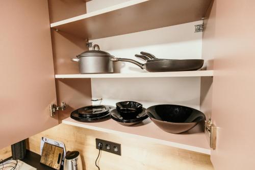 a kitchen with two pots and pans on shelves at Bascarsijaapart OWL parking included in Sarajevo