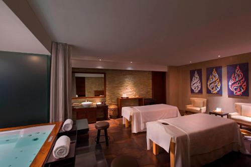 a hotel room with two beds and a pool at Sheraton Grand Bangalore Hotel at Brigade Gateway in Bengaluru