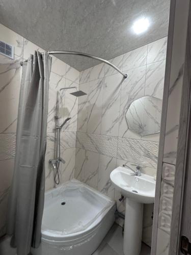 a bathroom with a sink and a tub and a toilet at Квартира in Gyumri
