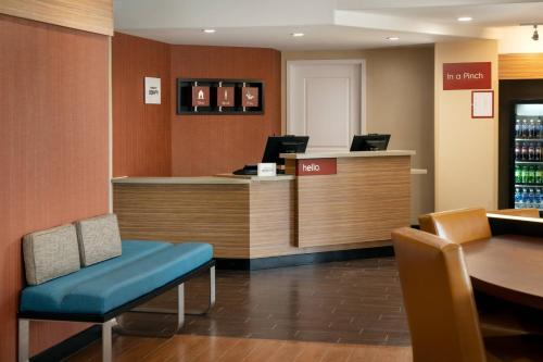 a bar in a restaurant with a table and chairs at TownePlace Suites Fresno Clovis in Clovis