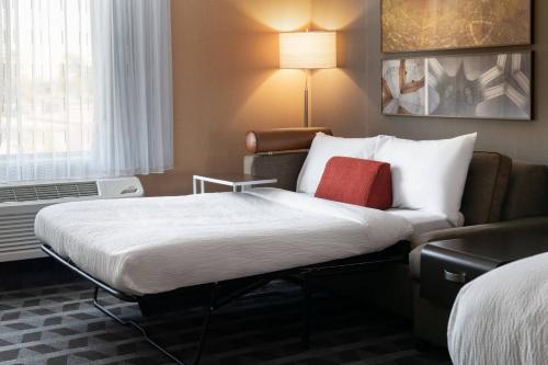 a hotel room with a bed and a couch at TownePlace Suites Fresno Clovis in Clovis
