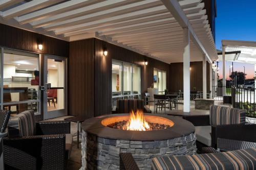 a fire pit on a patio with chairs and tables at TownePlace Suites Fresno Clovis in Clovis