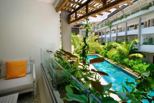 an apartment balcony with a swimming pool and plants at laïla, Seychelles, a Tribute Portfolio Resort in Mahe
