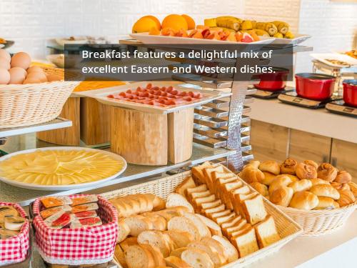 a bakery with bread and pastries on a counter at HOTEL MYSTAYS Fuji Onsen Resort in Fujiyoshida