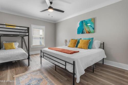 a bedroom with a bed with a ceiling fan at Beach Retreat in Gulfport