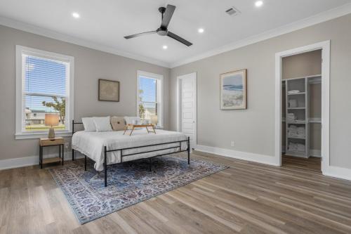 a bedroom with a bed and a ceiling fan at Beach Retreat in Gulfport