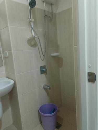 a shower with a blue bucket in a bathroom at Roxas Blvd Stunning Studio Condo Near US Embassy in Manila