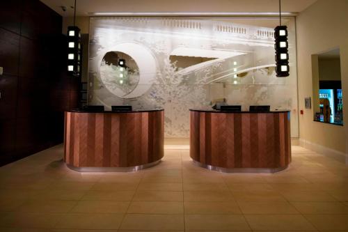a lobby with two wooden counters and a glass wall at Milwaukee Marriott Downtown in Milwaukee