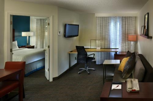 a hotel room with a bed and a desk at Residence Inn Mystic Groton in Mystic