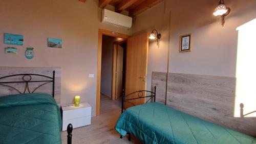 a bedroom with two beds in a room at Profumo di Zagara Acireale in Acireale