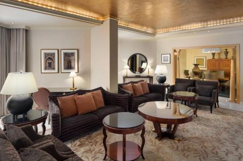 a living room with a couch and tables at Sheraton Dammam Hotel & Convention Centre in Dammam