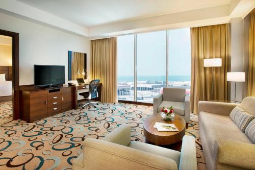 a living room with a couch and a television at Residence Inn by Marriott Jazan in Jazan