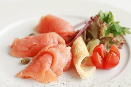 a plate of food with salmon and vegetables on it at Residence Inn by Marriott Jazan in Jazan
