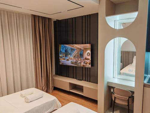 a hotel room with two beds and a mirror at Planet Lux Apartment in Niš