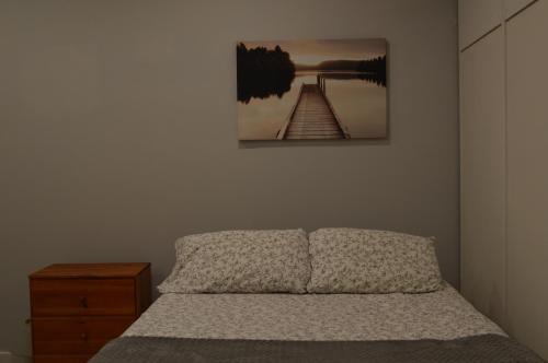 a bedroom with a bed and a picture on the wall at Cozy Retreat Near Westport in Fairfield