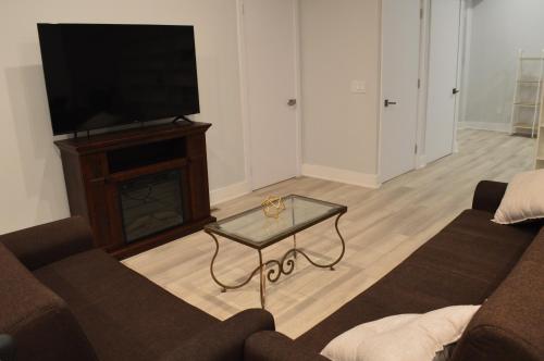 a living room with a couch and a tv at Cozy Retreat Near Westport in Fairfield