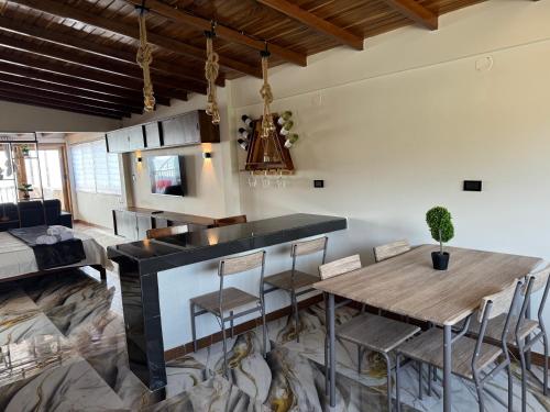 a kitchen and dining room with a table and chairs at Las Olas del Surf in Ayampe