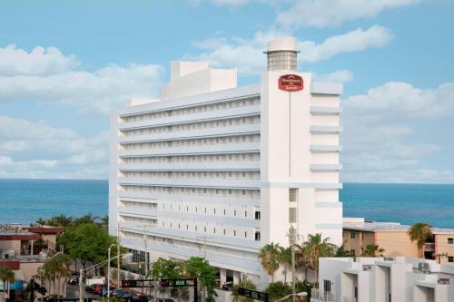a large white building with a lighthouse on top of it at Residence Inn Fort Lauderdale Pompano Beach/Oceanfront in Pompano Beach