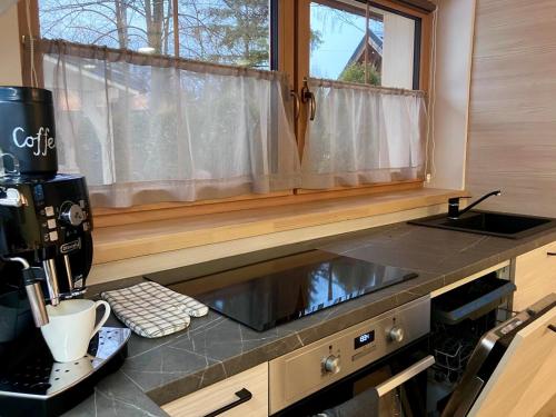 a kitchen with a coffee machine on a counter at Apartmány Roháče in Zuberec