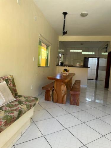 a living room with a couch and a table at CASA DE PRAIA COM PISCINA EM ILHÉUS-BA a 50m DA PRAIA in Ilhéus
