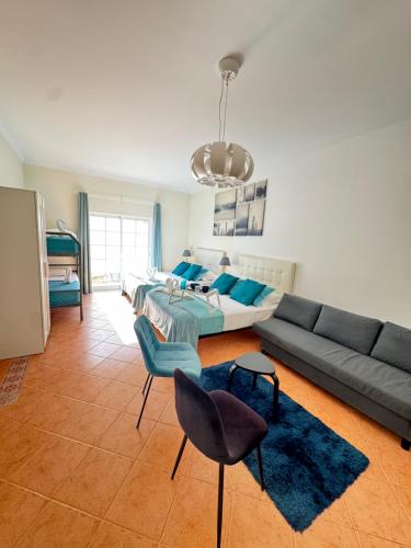 a living room with a couch and a table and chairs at Villa Bonita Guesthouse Albufeira Old Town in Albufeira
