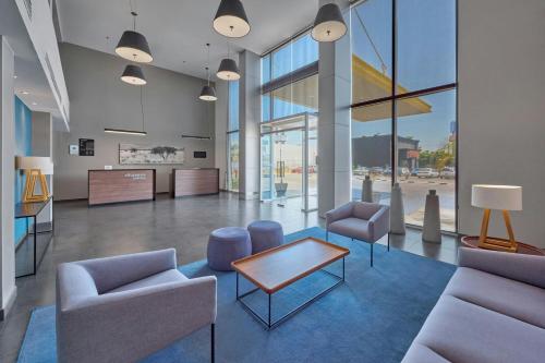 a lobby with chairs and a table in a building at City Express by Marriott Mexicali in Mexicali