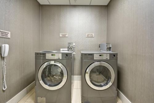 two washing machines in a laundry room with a phone at SpringHill Suites by Marriott San Antonio Medical Center/Northwest in San Antonio