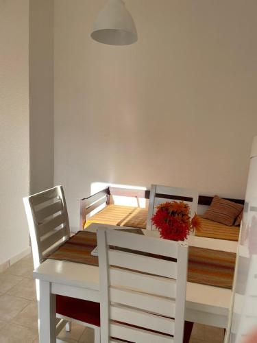 a white dining table and chairs with a white table and a table and a table at Delicado departamento en Formosa in Formosa