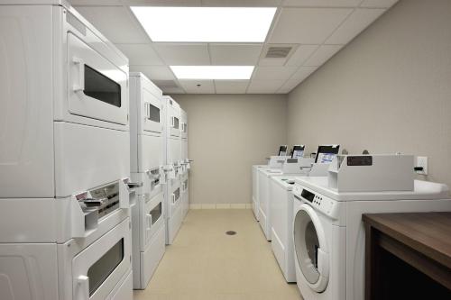 a laundry room with white washers and dryers at Residence Inn by Marriott Houston NW Cypress in Cypress