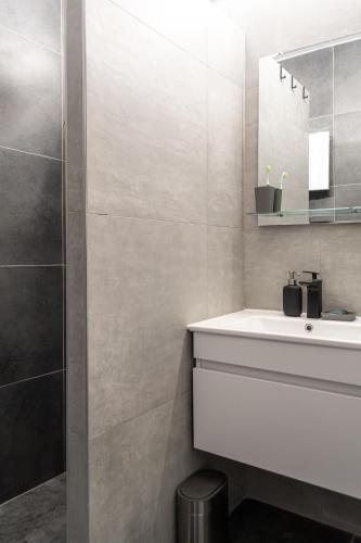 a bathroom with a white sink and a mirror at Studio Bele Staze Central in Brzeće