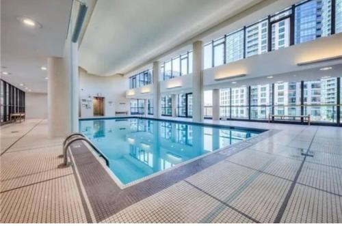 a large swimming pool in a large building at Luxury Downtown Condo with CN tower views, Pool Access, Gym,Free Parking upon request at booking, accommodates 4 in Toronto