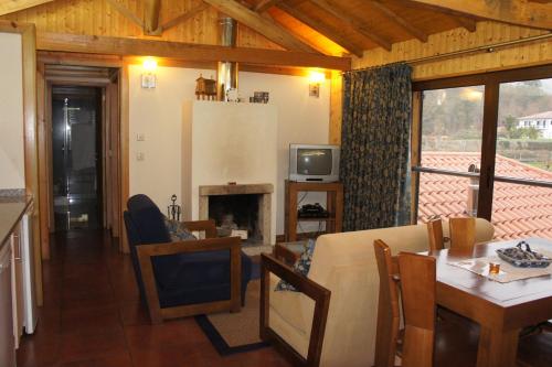 a living room with a couch and a fireplace at Quinta Travessa in Vieira do Minho