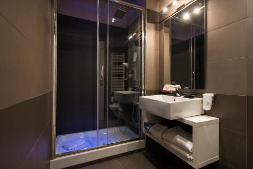 a bathroom with a sink and a shower at San Pietro Suites in Rome