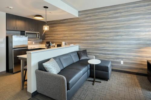 a living room with a couch and a kitchen at Residence Inn by Marriott Harrisburg North in Harrisburg